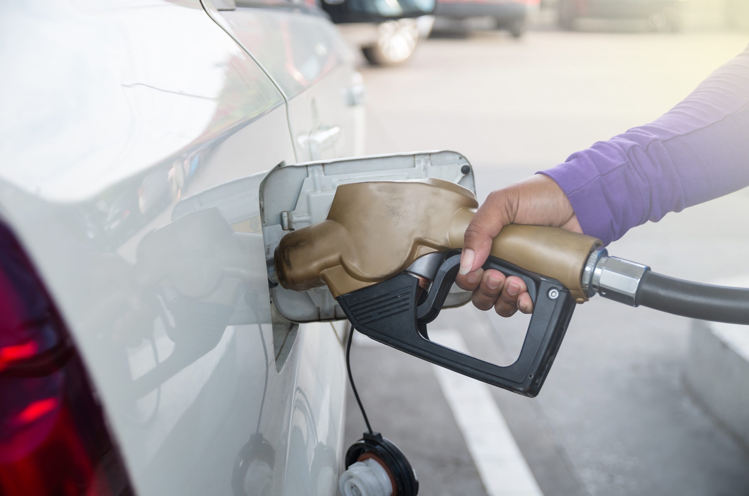 person filling gas tank