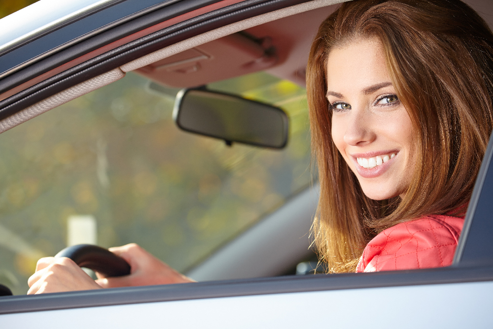 woman in car smiling